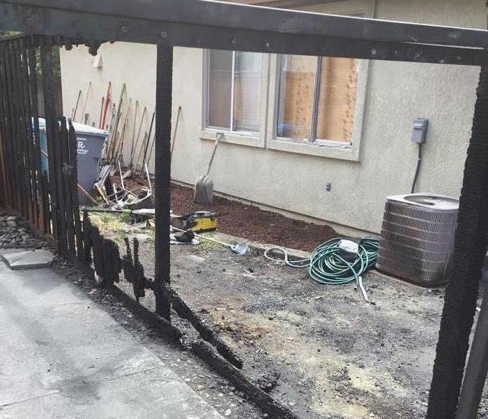 Picture shows burned fence and ground